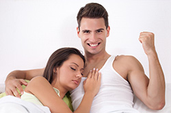Satisfied Man Yes Fist in Bed with Woman